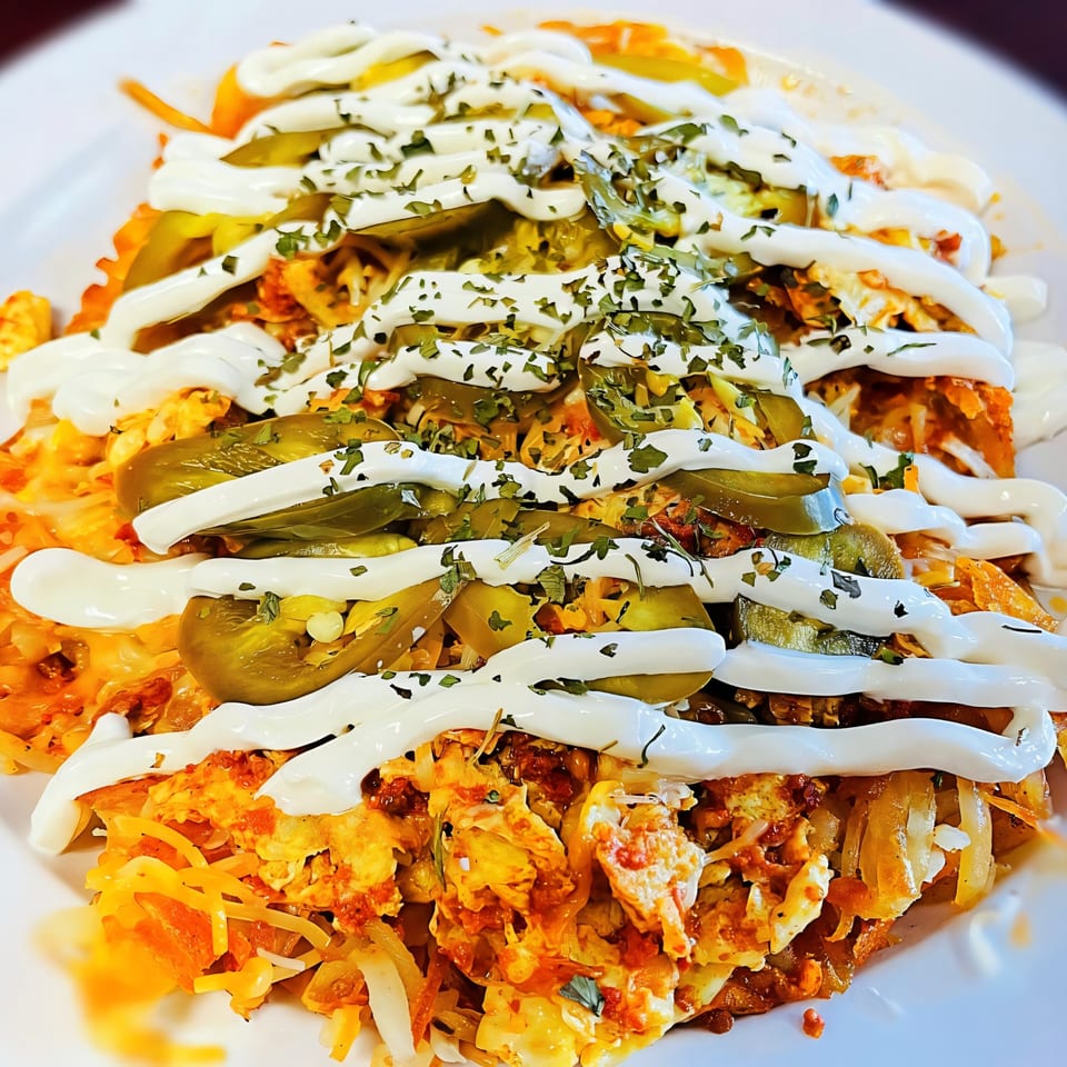 Sweet Desert Cafe's breakfast hash with scrambled eggs, cheese, jalapeños, sour cream, and parsley.